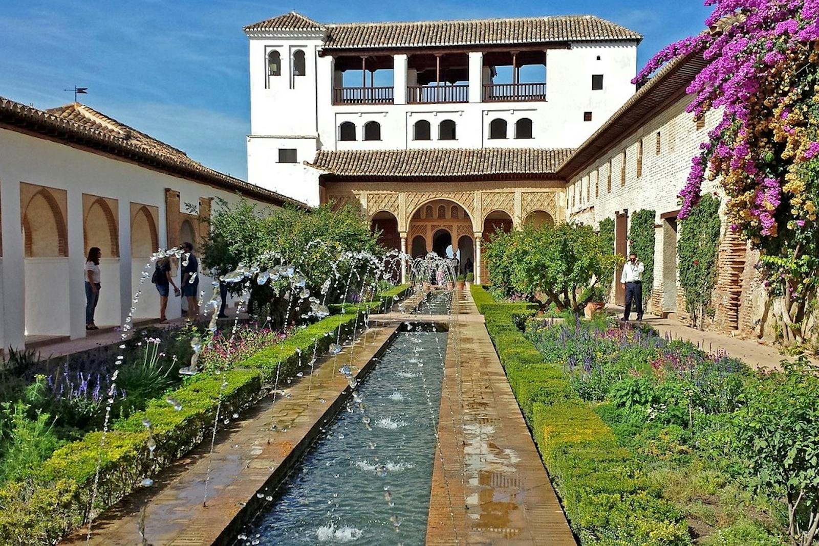 View of the Alhambra patio with fountain and gardens