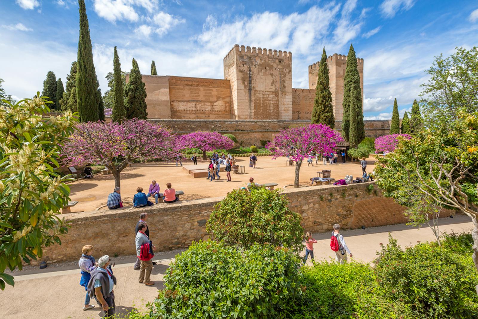 View of the Alhambra with its flowered gardens and visitors