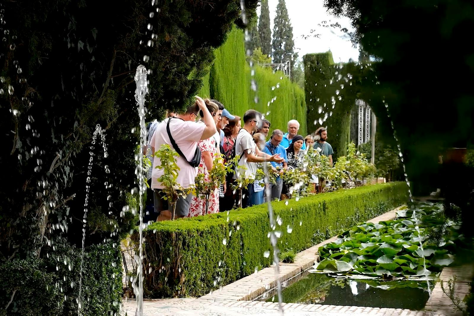 Visitors admiring the fountains and gardens of the Alhambra