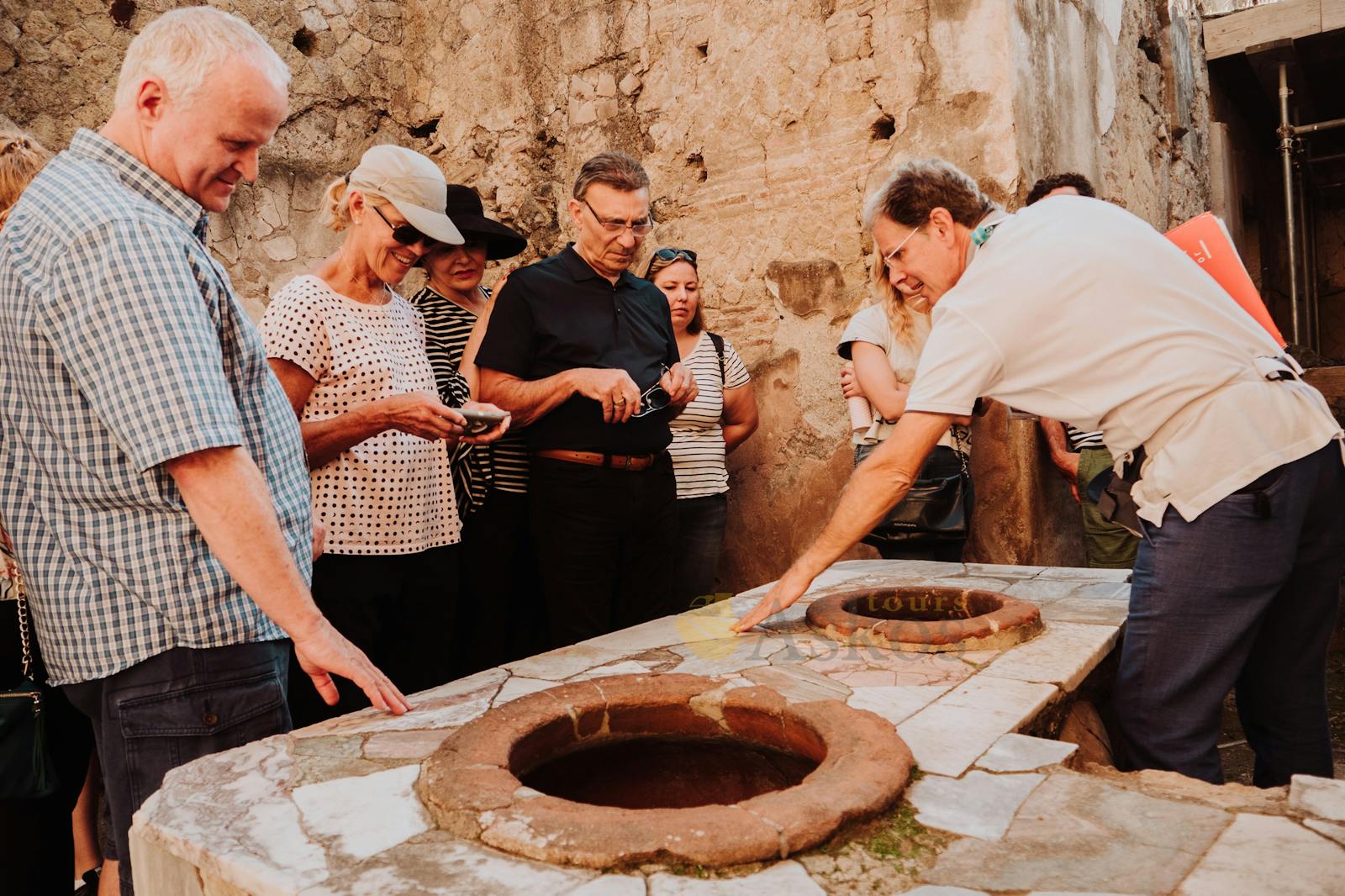 Tour guide explaining ancient ovens at Herculaneum
