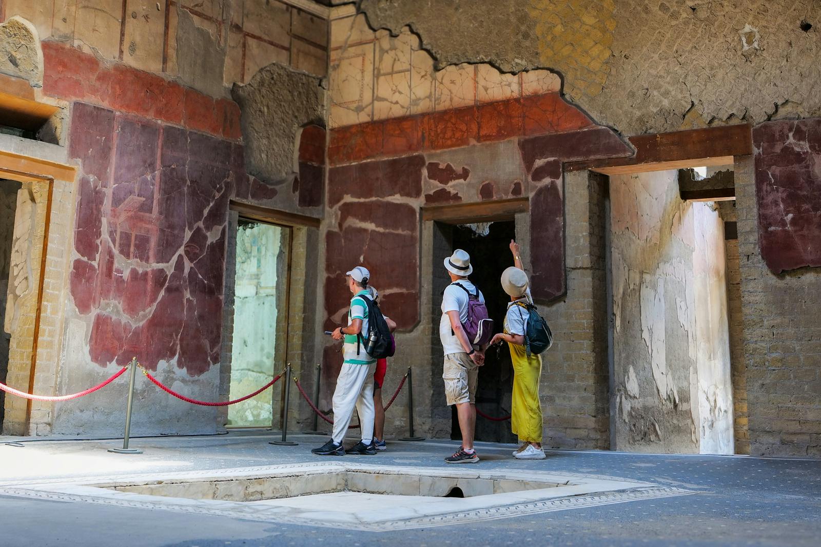 Visitors admiring the ancient frescoes of Herculaneum